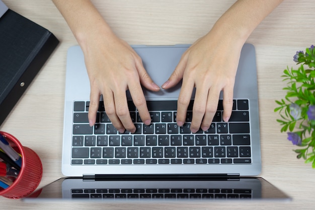 Photo typing on keyboard of laptop. using computer for working or playing internet.