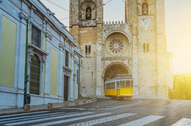 Typische gele tram die de wijk Alfama opgaat voor de kathedraal van Lissabon Portugal