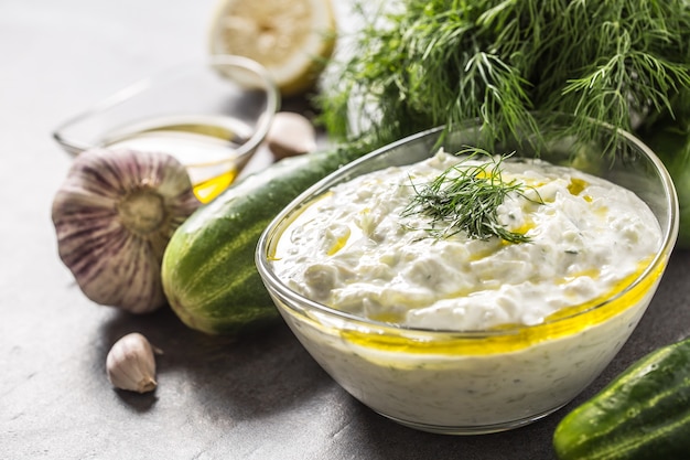 Tzatziki sause in a glass bowl dill cucumber olive oil lemon and garlic.