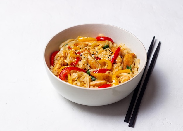 Udon noodles with chicken, pepper and sesame. Chinese food.