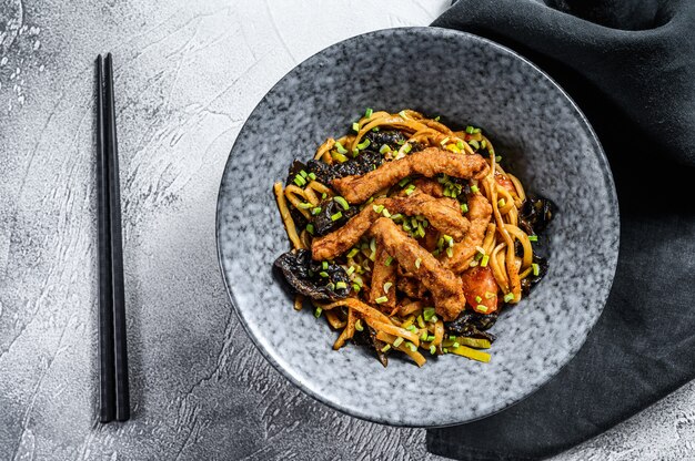 Udon stir fry noodles with pork meat and vegetables