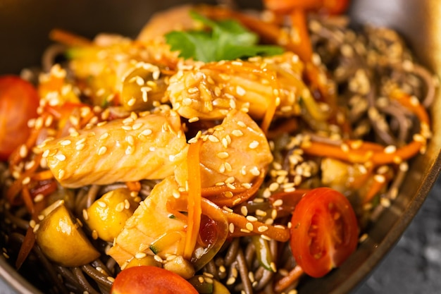 Udon stirfry noodles with salmon and vegetables Asian cuisine