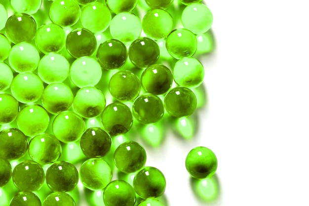 Ufo green spherical ball capsules with selective focus isolated on white background