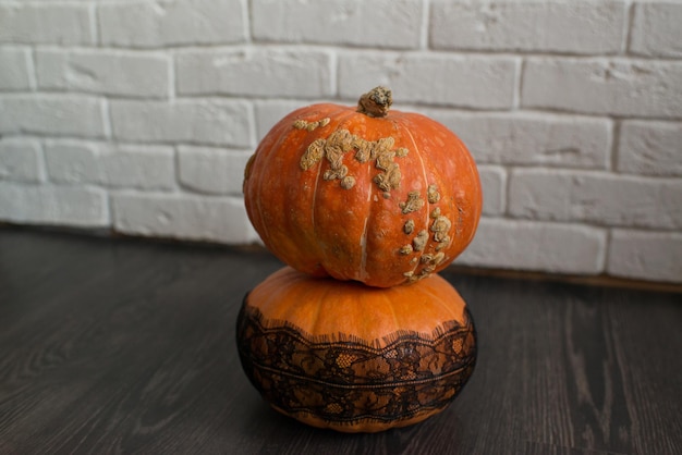 Ugly autumn pumpkins on the black floor