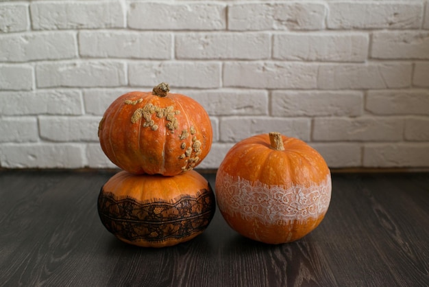 Ugly autumn pumpkins on the black floor
