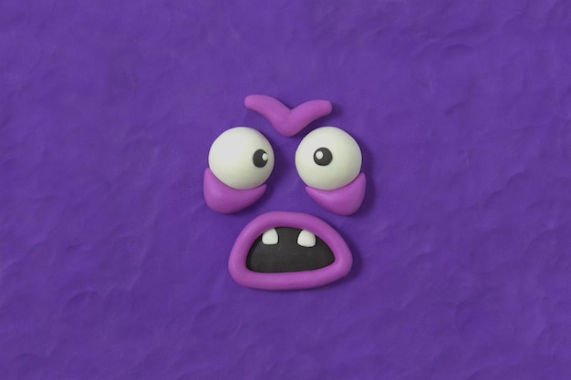 Ugly monster with furious expression Fabulous creature made by hand from purple plasticine