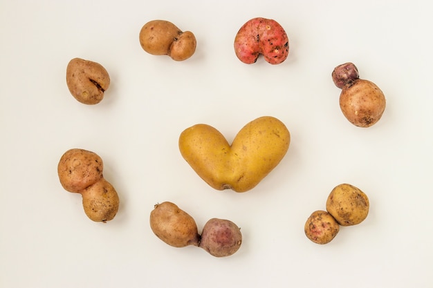 Ugly organic abnormal vegetables - potatoes on white background, Concept organic vegetables, Top view, Horizontal orientation