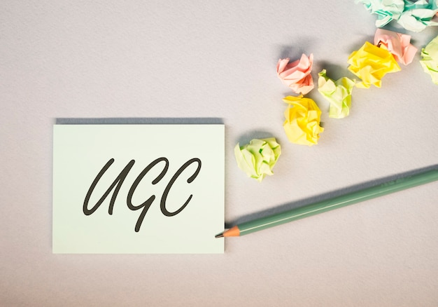 UGS or User-generated content acronym for social media on colorful bright sticky notes with crumpled papers.