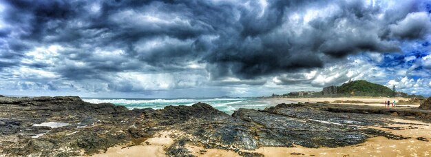 Foto uitzicht op een rustig strand tegen een bewolkte lucht