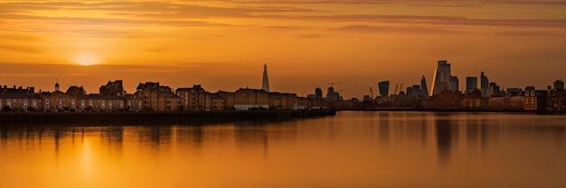 Foto uitzicht op gebouwen aan de waterkant bij zonsondergang