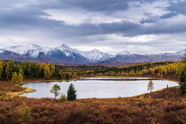 Uitzicht op Kidelu Lake en besneeuwde toppen van Kurai Ridge. Herfst berglandschap. Altaj, Rusland