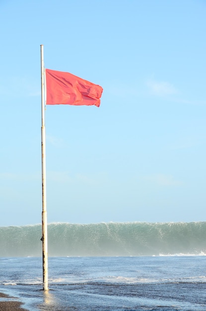 Uitzicht op stormzeegezicht en rode vlag