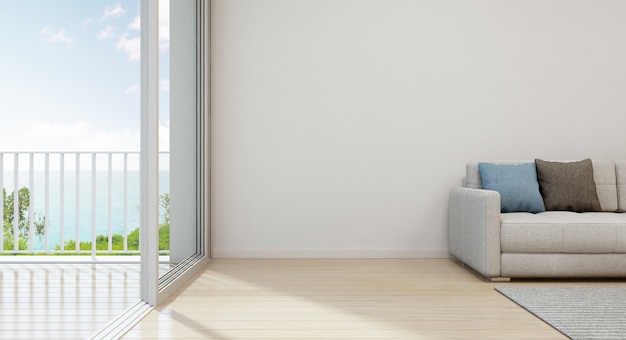 Uitzicht op zee woonkamer van luxe strandhuis met modern meubilair in de buurt van glazen deur