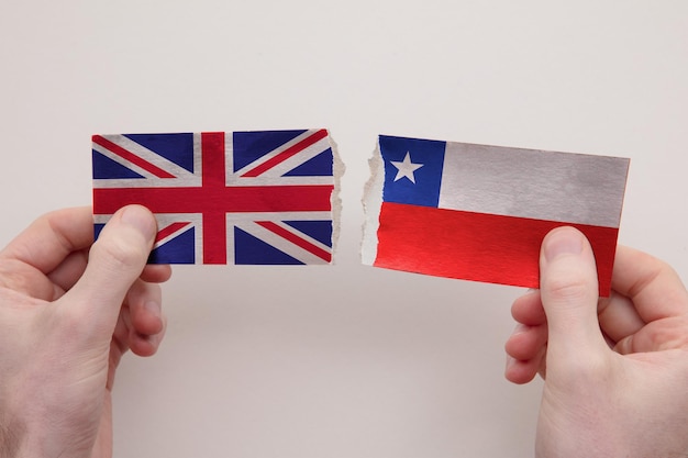 UK and Chile paper flags ripped apart political relationship concept