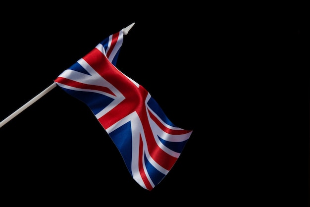 The uk flag on a dark background waving in the wind