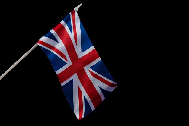 The uk flag on a dark background waving in the wind