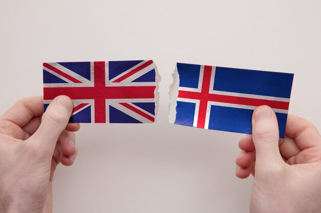 UK and Iceland paper flags ripped apart political relationship concept