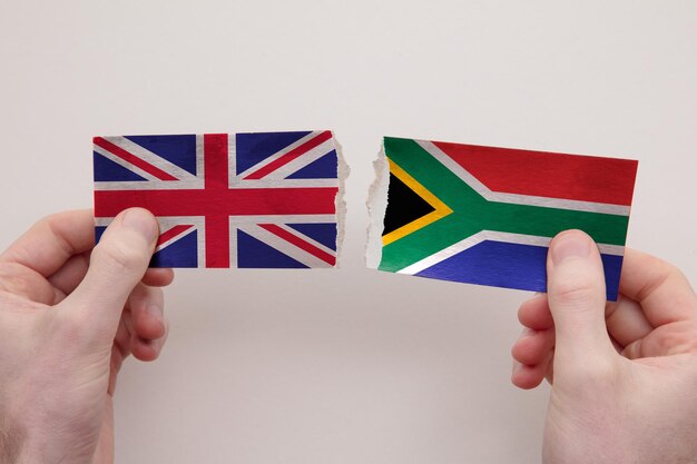 Uk and south africa paper flags ripped apart political relationship concept