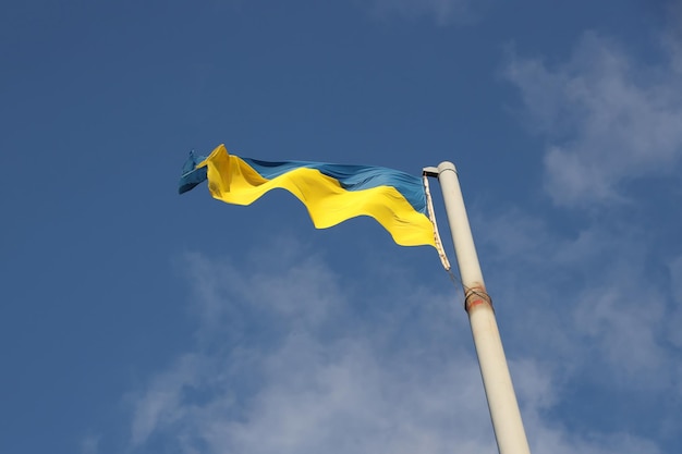 Ukraine flag large national symbol fluttering in blue sky large yellow blue ukrainian state flag