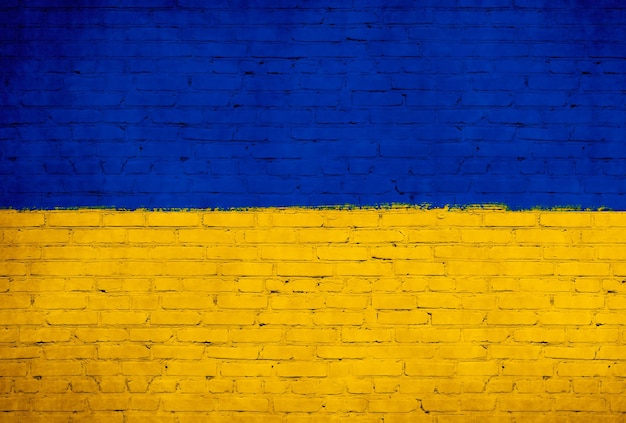 벽돌 벽에 그려진 우크라이나 국기 국기 배경 사진