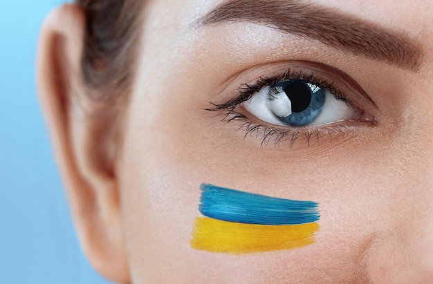 Ukraine flag painted over female face ukraine crisis concept