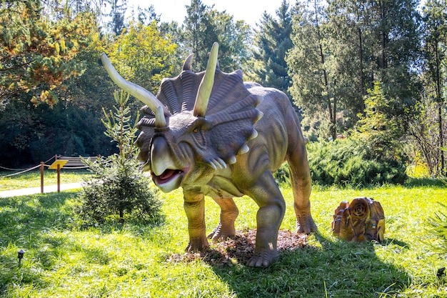 Ukraine, Khmelnitsky, October 2021.Dinosaur model in the park. Giant triceratops on exhibition in the park on a summer sunny day