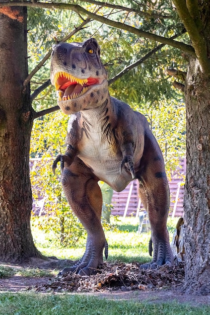 Ukraine, Khmelnitsky, October 2021. Dinosaur model in the park. Giant tyrannosaurus at an exhibition in the park on a summer sunny day