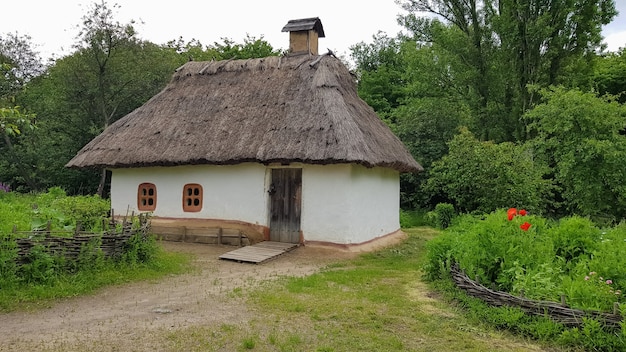 Ukraine, Kiev - June 11, 2020. The old house of peasants in the museum Pirogovo. National Museum of Folk Architecture and Everyday Life of Traditional Folklore Houses of Different Regions of Ukraine.