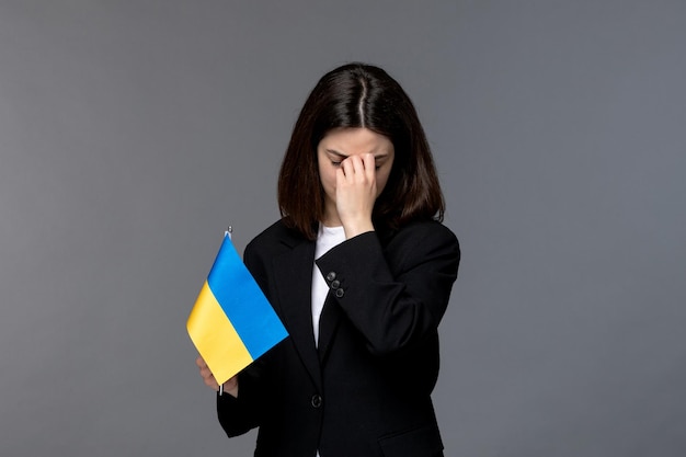 Ukraine russian conflict brunette pretty cute girl in black blazer upset with closed eyes