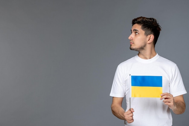 Ukraine russian conflict courageous handsome guy in white shirt with looking up and hoping