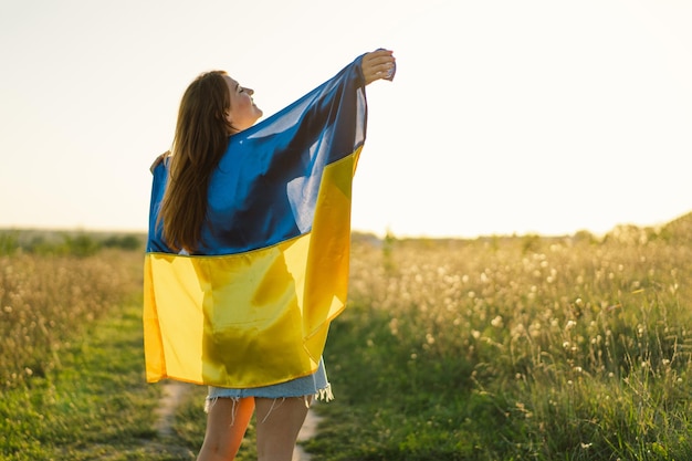 Ukraine's Independence Day Ukrainian woman with yellow and blue flag of Ukraine in field Flag of Ukraine Constitution day Stand with Ukraine Save Ukraine