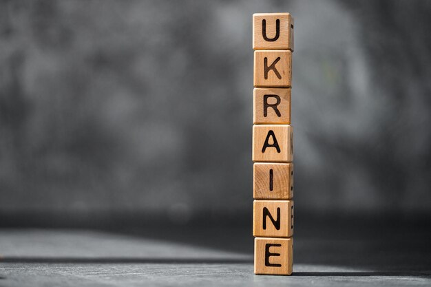 Ukraine word is made of wooden blocks on the dark table