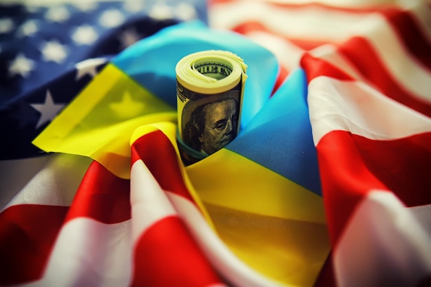 Photo ukrainian and american flags a pack of american dollars aid and lendlease concept