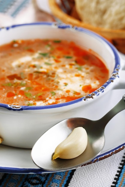 Ukrainian beetroot soup borscht on blue napkin on wooden background