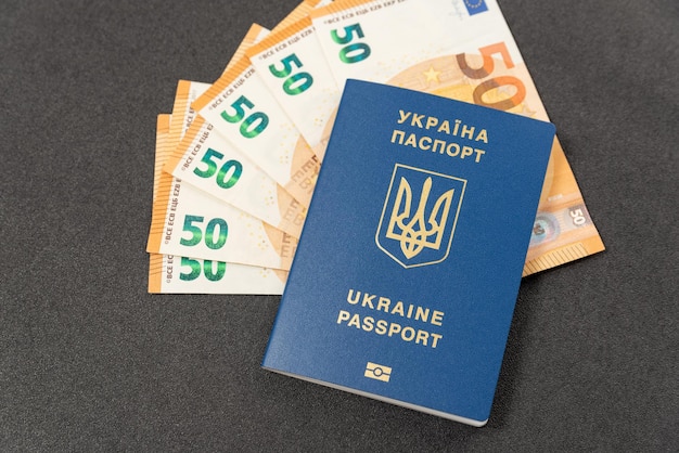 Ukrainian Biometric passport and money euros cash Concept monetary compensation or cash payments to Ukrainians