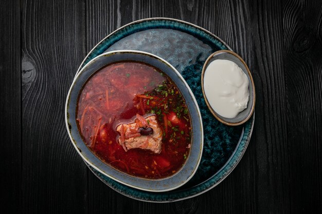 Ukrainian borsch on a dark wooden table