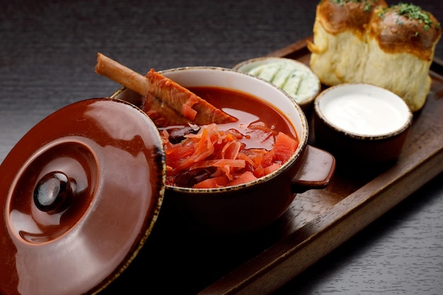 Ukrainian borscht with sour cream on a wooden board