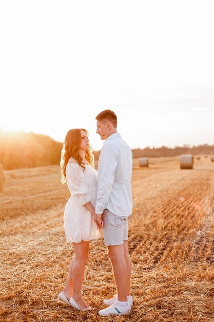 A Ukrainian couple walks through a field and looks into each other's eyes