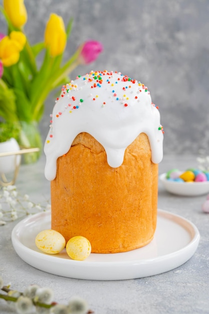 Ukrainian Easter cake Kulich with sugar glaze and colored sugar candies Paska Easter Bread