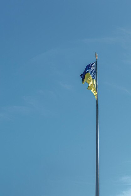 Ukrainian flag against the blue sky closeup