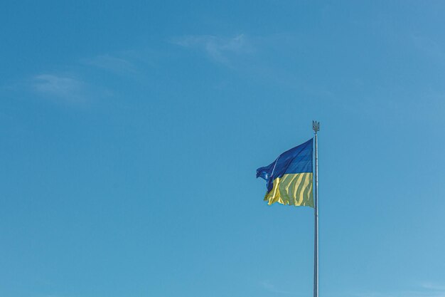 Ukrainian flag against the blue sky closeup