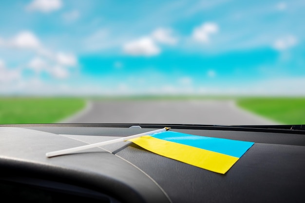 Ukrainian flag on glass inside the car