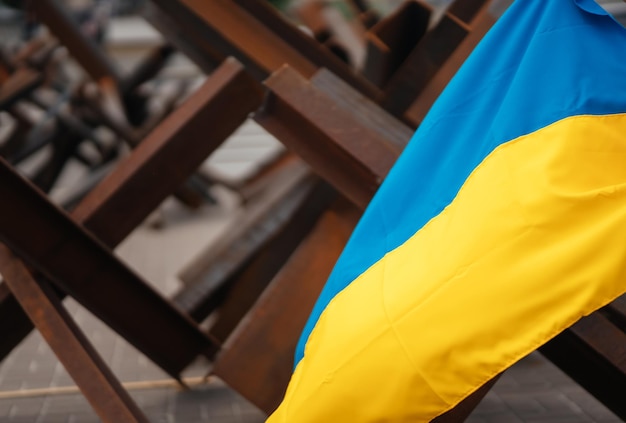 The Ukrainian flag hangs on barricades in the city