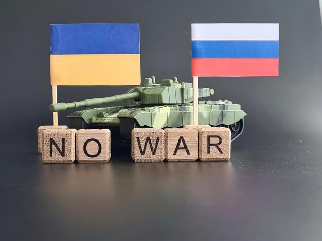 Ukrainian flag and Russian flag with a tank and inscription no war