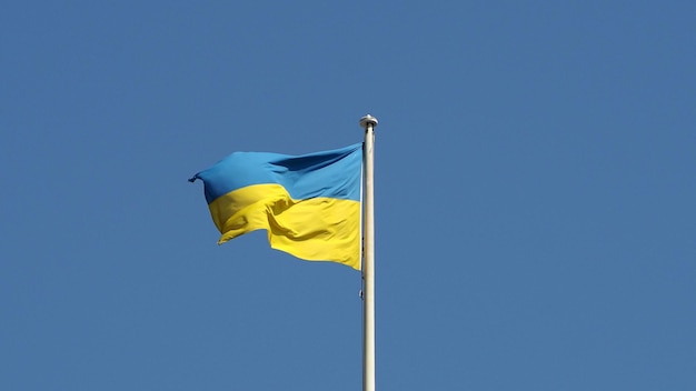 Ukrainian flag of Ukraine over blue sky