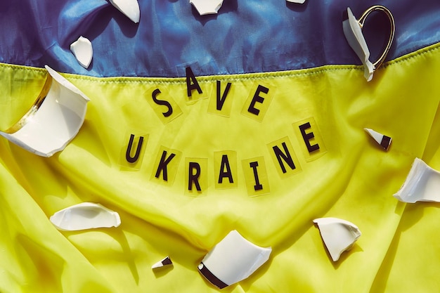 Ukrainian flag with broken pieces of cup symbol of sovereignty of Ukraine Stop war in Ukraine.