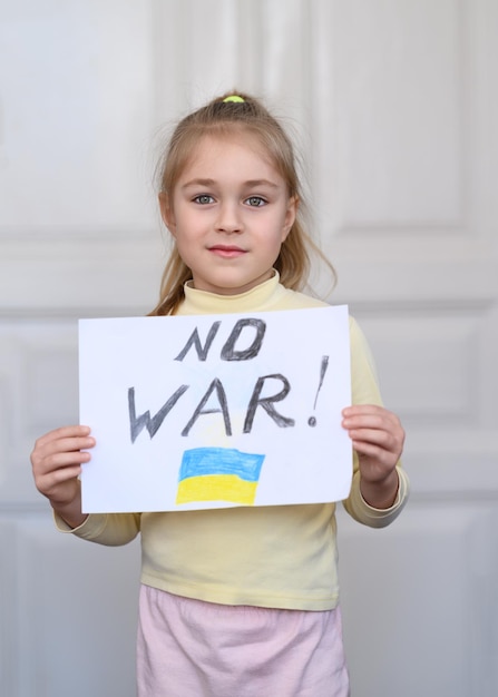 Ukrainian girl kid protesting against war in Ukraine and holding message text No War