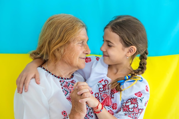 Ukrainian grandmother and granddaughter in vyshyvanka selective focus