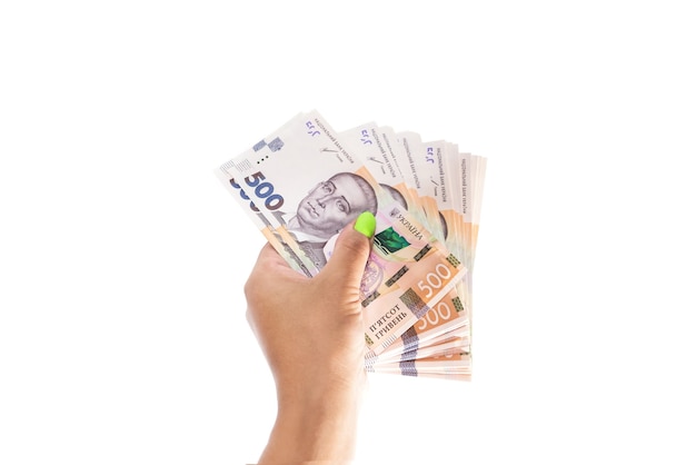 ukrainian hryvnia in a female hand on white