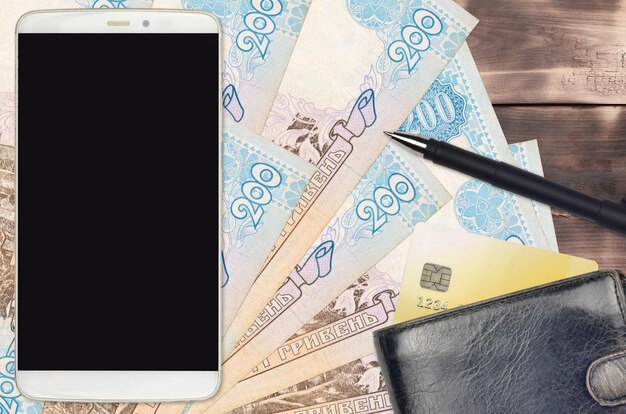 Ukrainian hryvnias bills and smartphone with purse and credit card